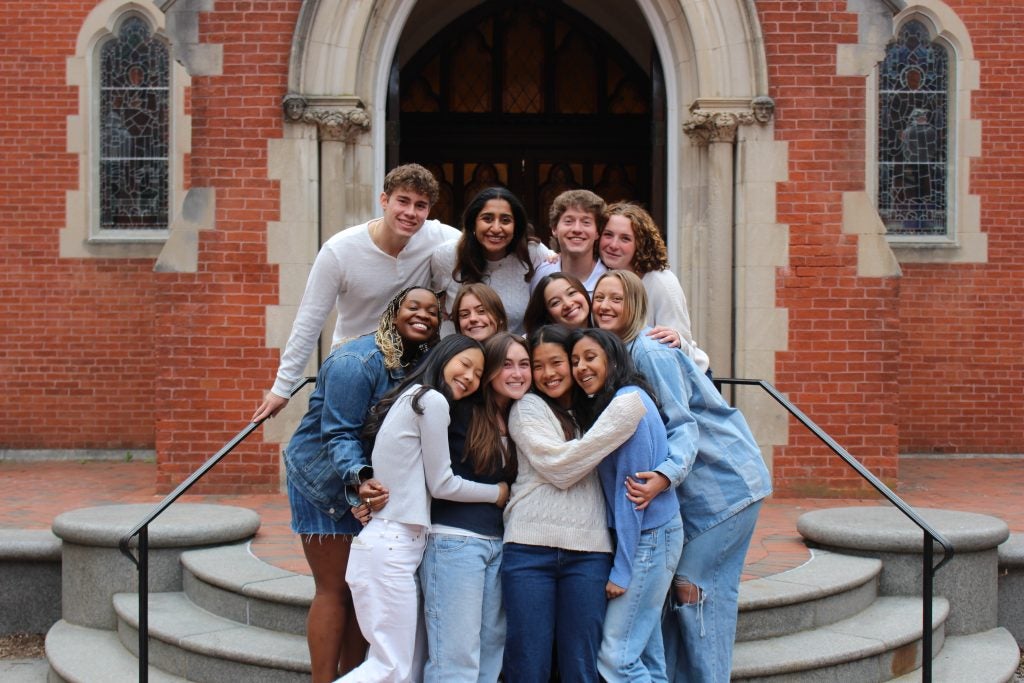 Group of college students in a group hug for a photo