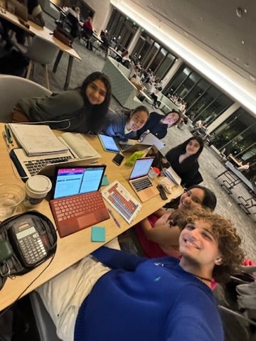 A group of students at a table in a library