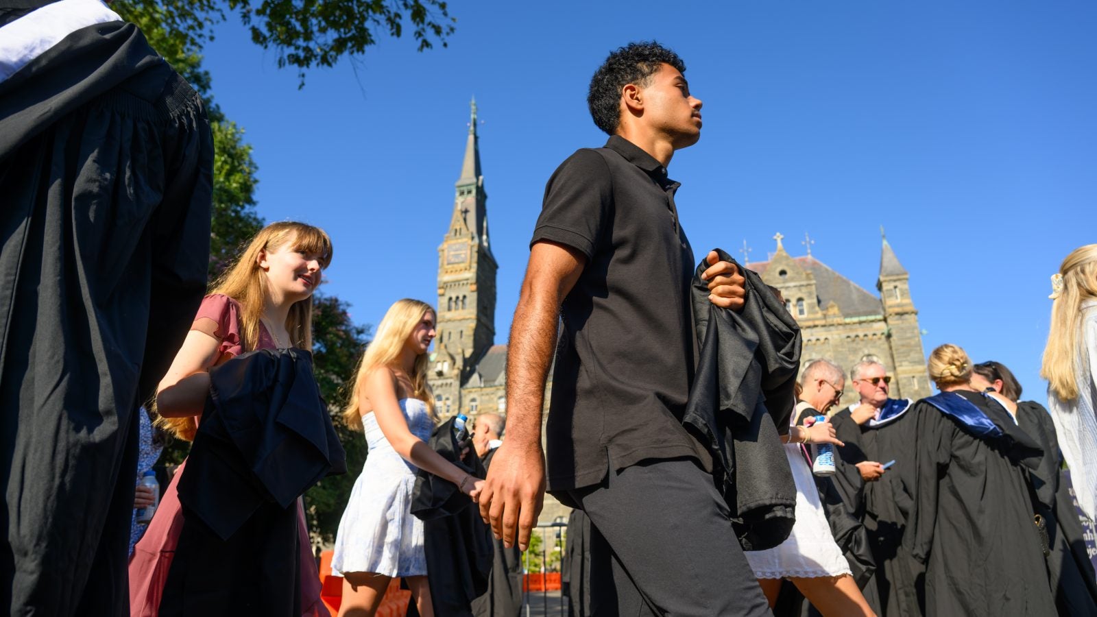 Students walking past Healy Hall on a clear day