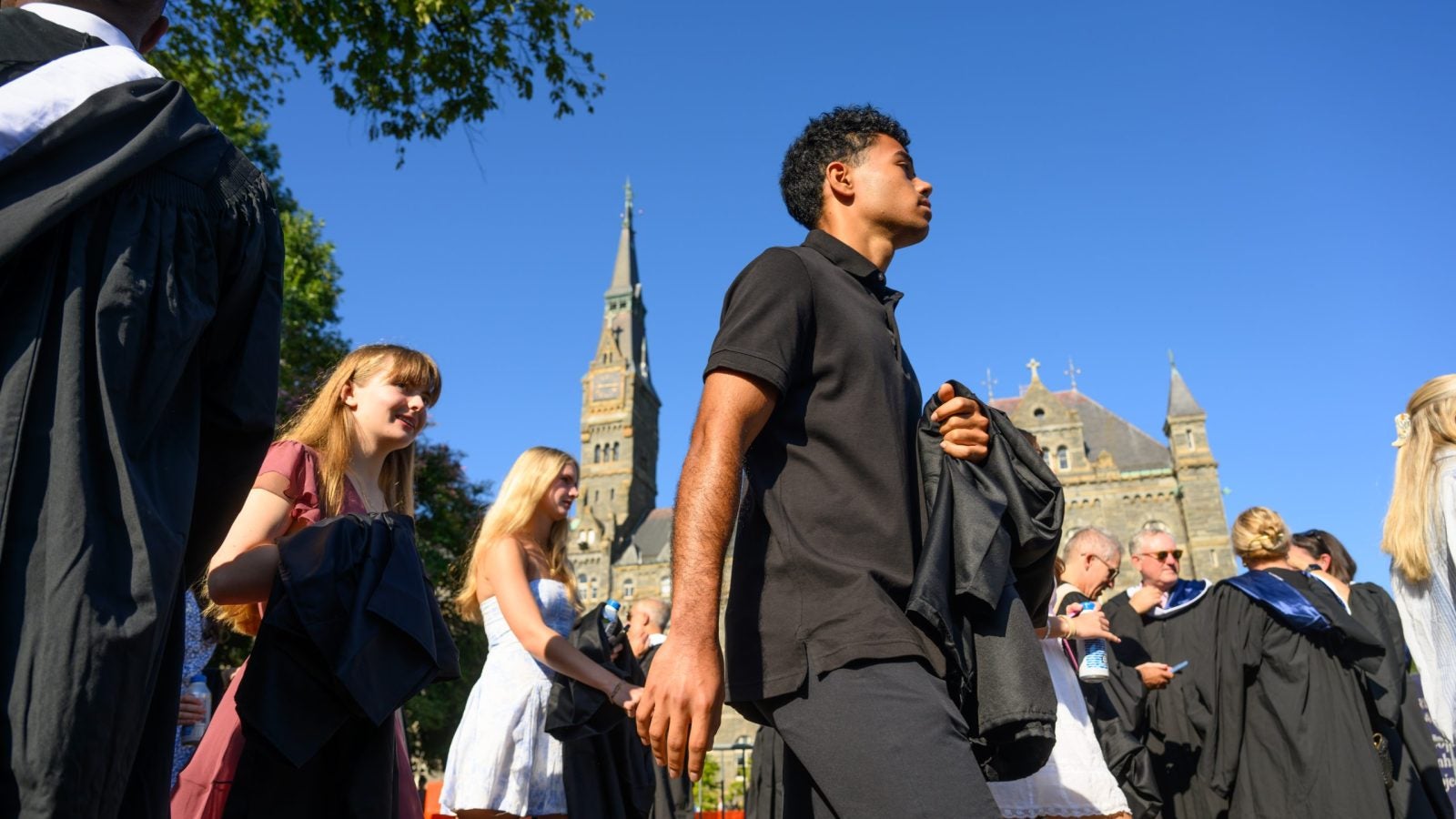 Students walking past Healy Hall on a clear day
