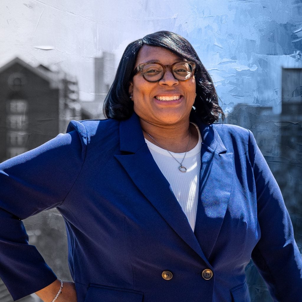 Smiling Black woman in a blue suit