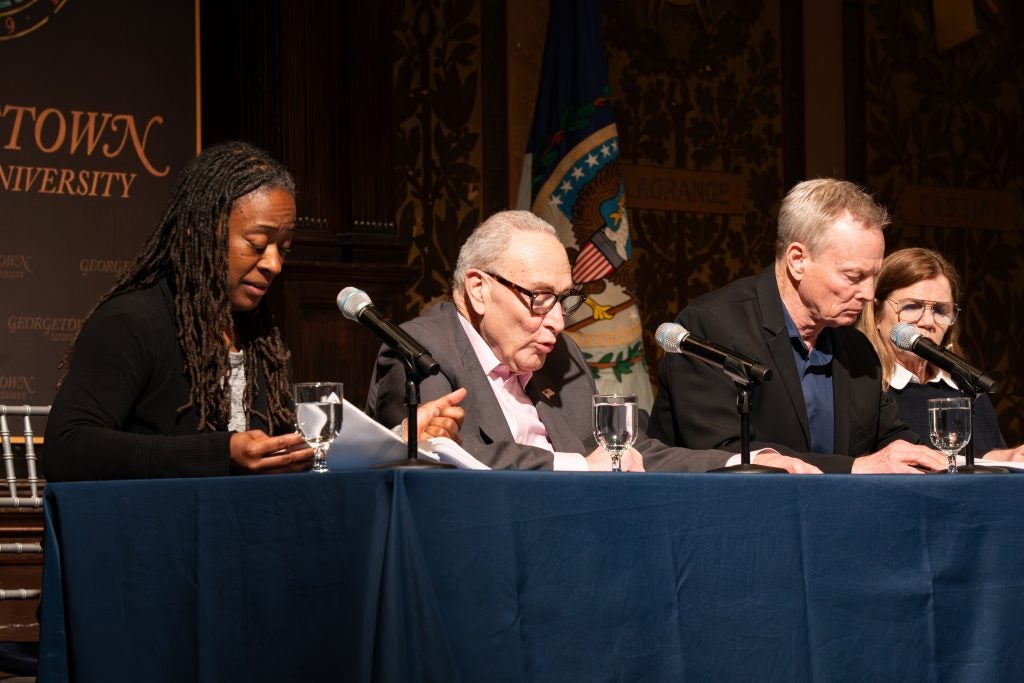 Chuck Schumer speaks on a panel during performance