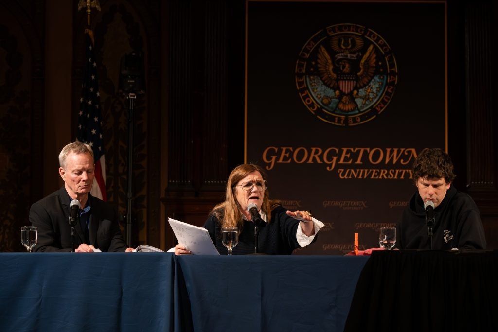 Woman speaks on stage during performance