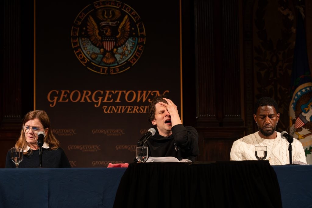 Jesse Eisenberg acts his part with a hand to his face during performance