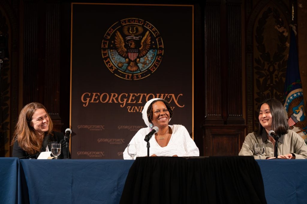 Three smiling women on stage