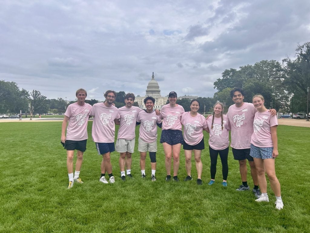 A group of students in pink t shirts on the National Mall