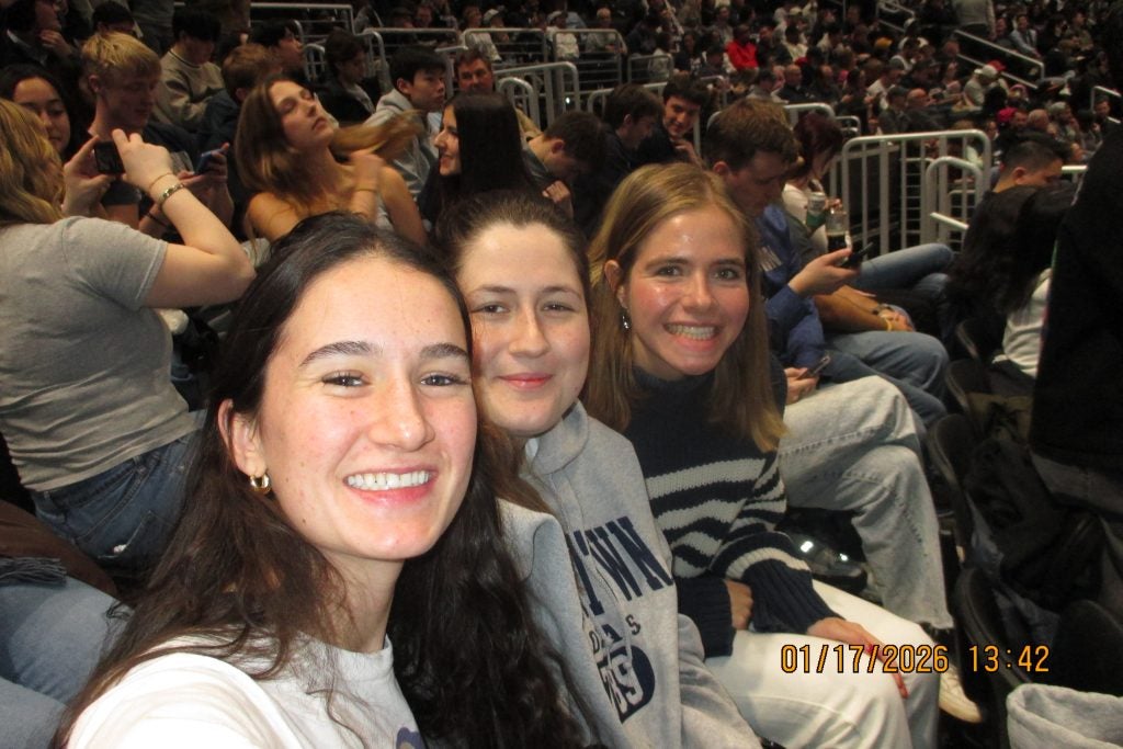 Three young women at a basketball game