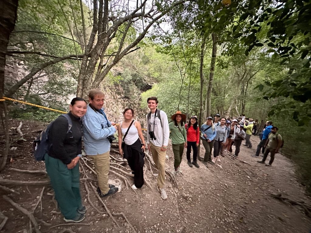 A group of students in a wooded area