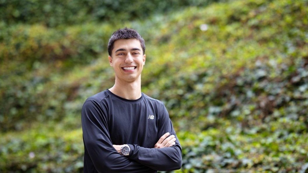 Young man in black shirt smiling