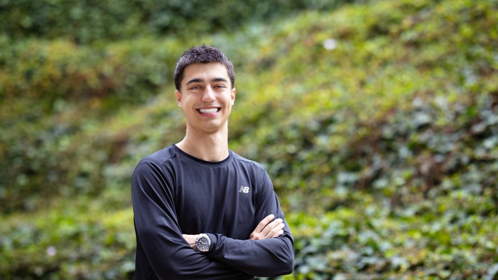 Young man in black shirt smiling