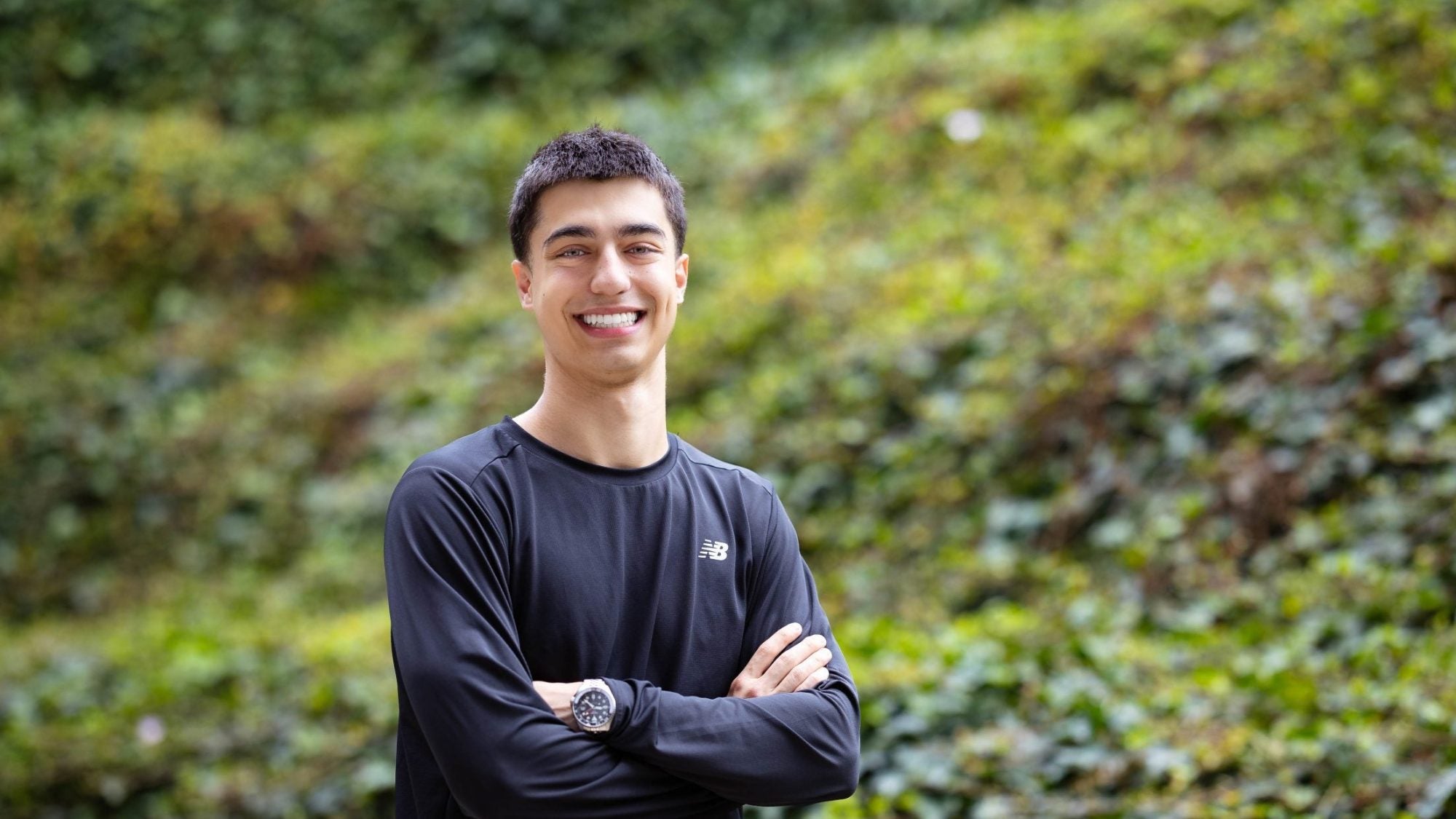 Young man in black shirt smiling