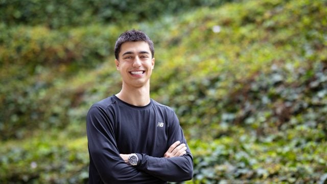 Young man in black shirt smiling