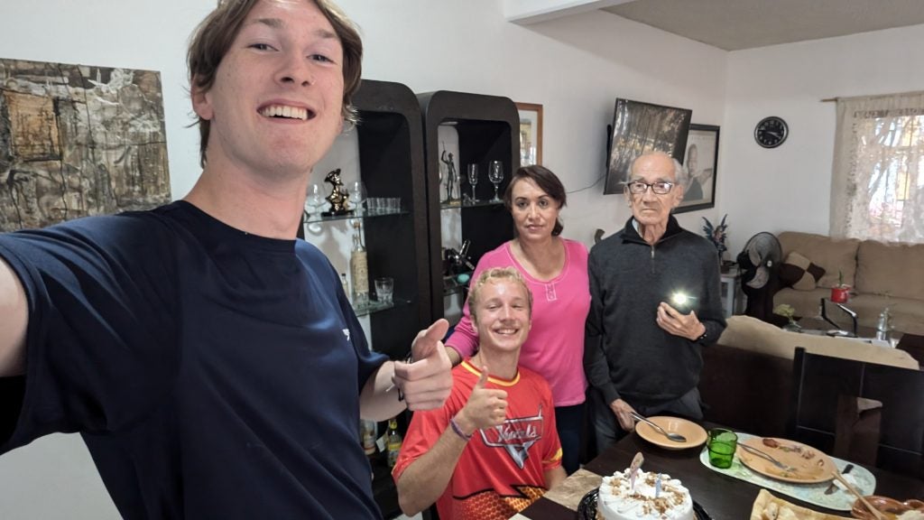 Four people in a house at meal time