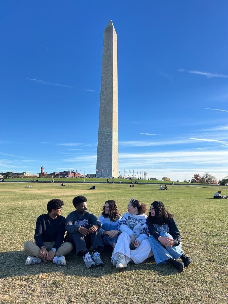 Five friends on the lawn in front of the Washington Monument
