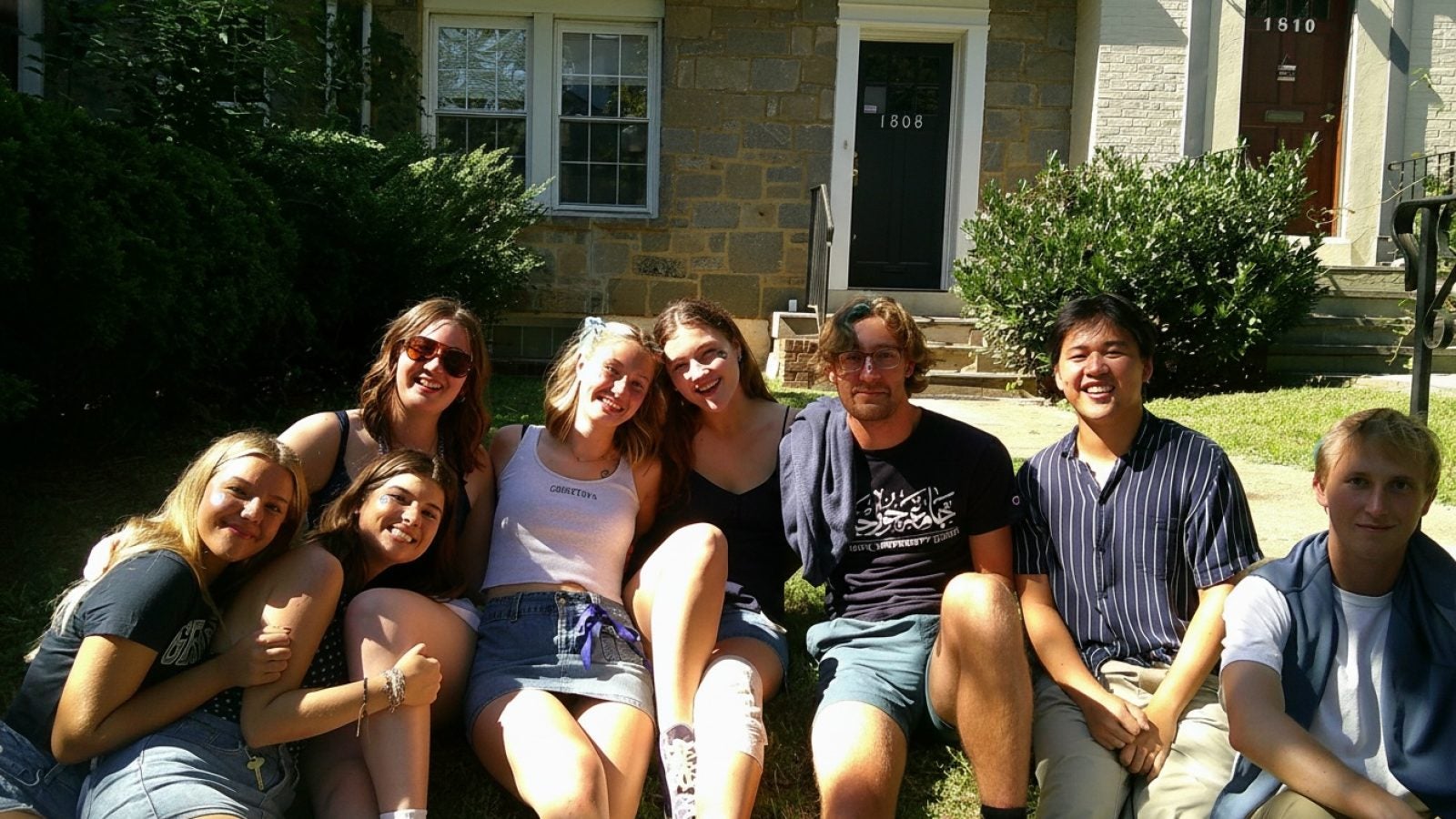 A group of college students outside on a sunny day