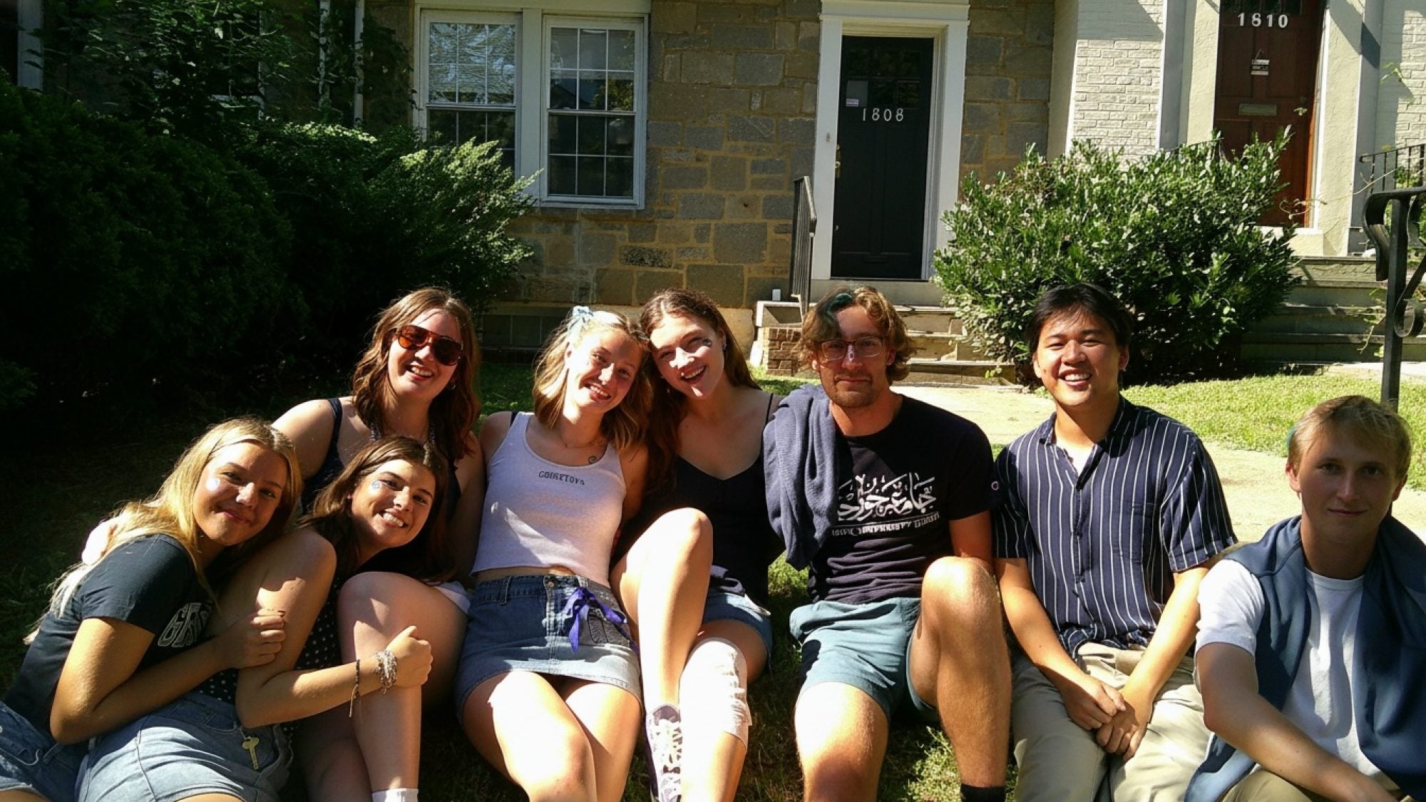 A group of college students outside on a sunny day