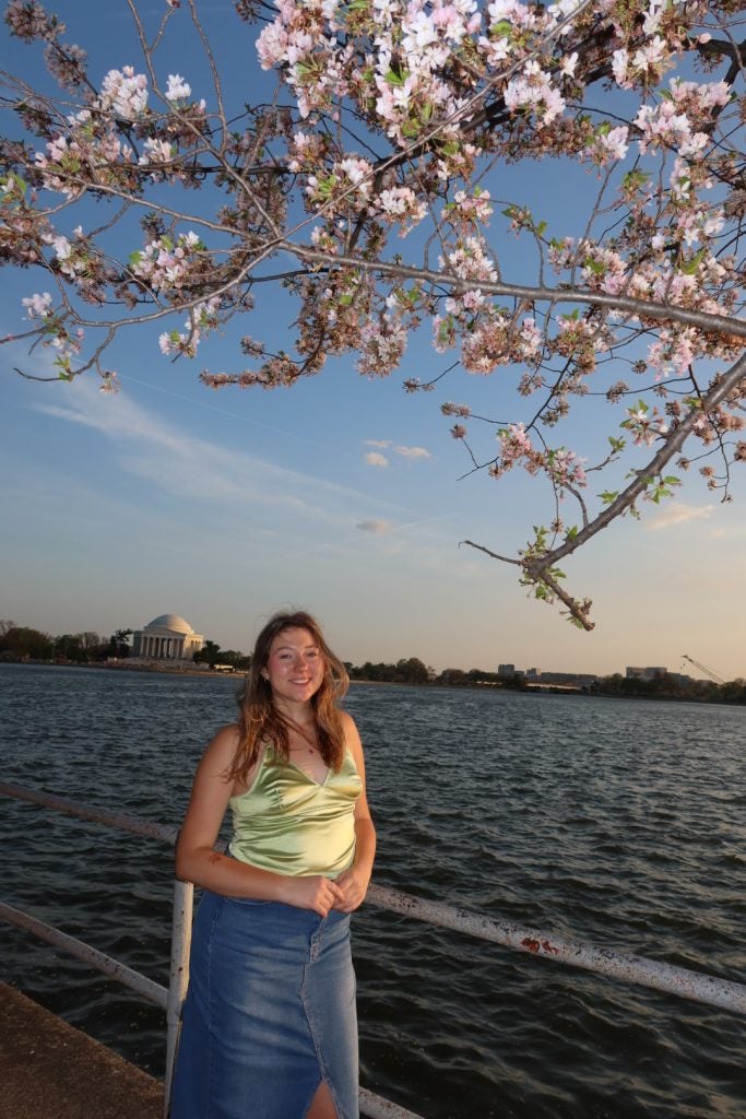 Young woman by cherry blossoms in DC