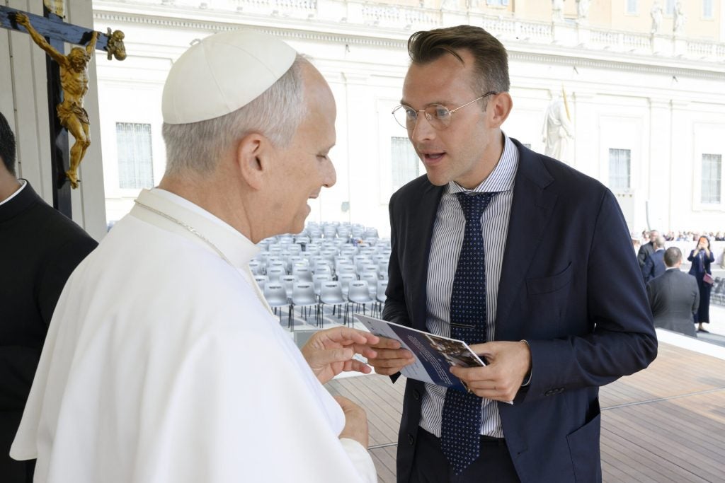 Pope Leo and a young man speak