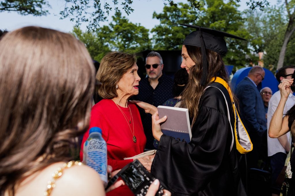 A grandmother looks on at her granddaughter on her graduation day