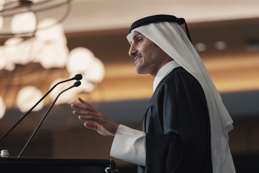 Arab man speaking at a podium
