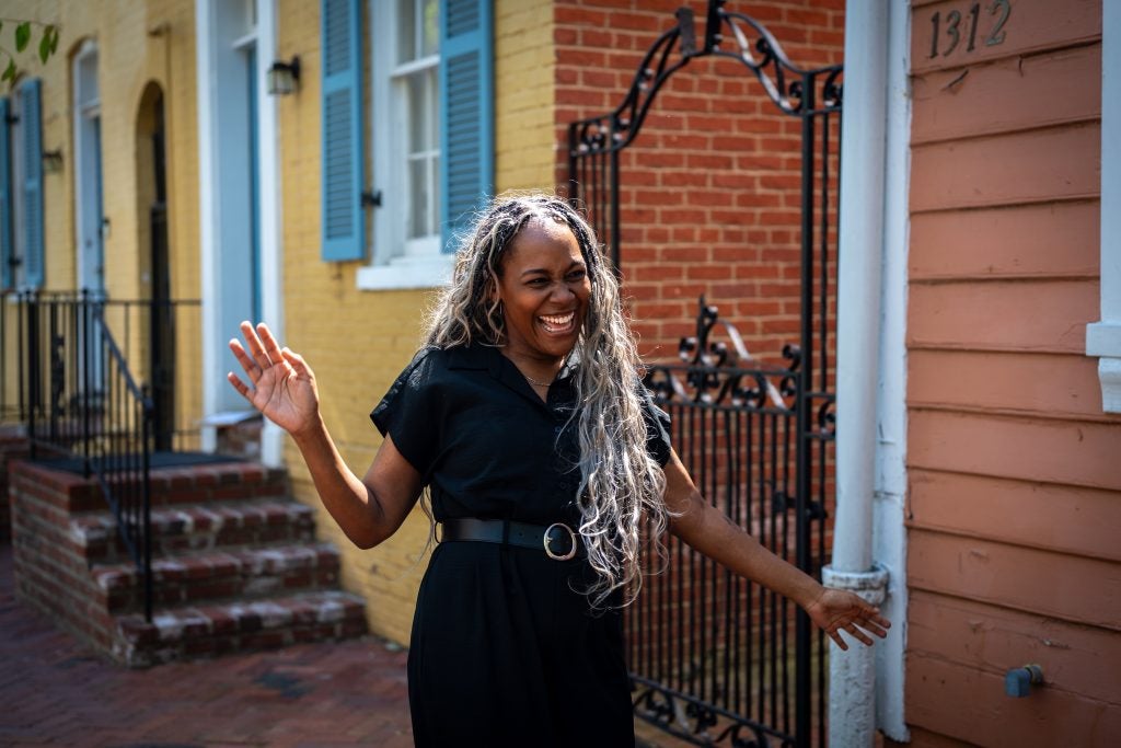 Black woman smiling while walking down street