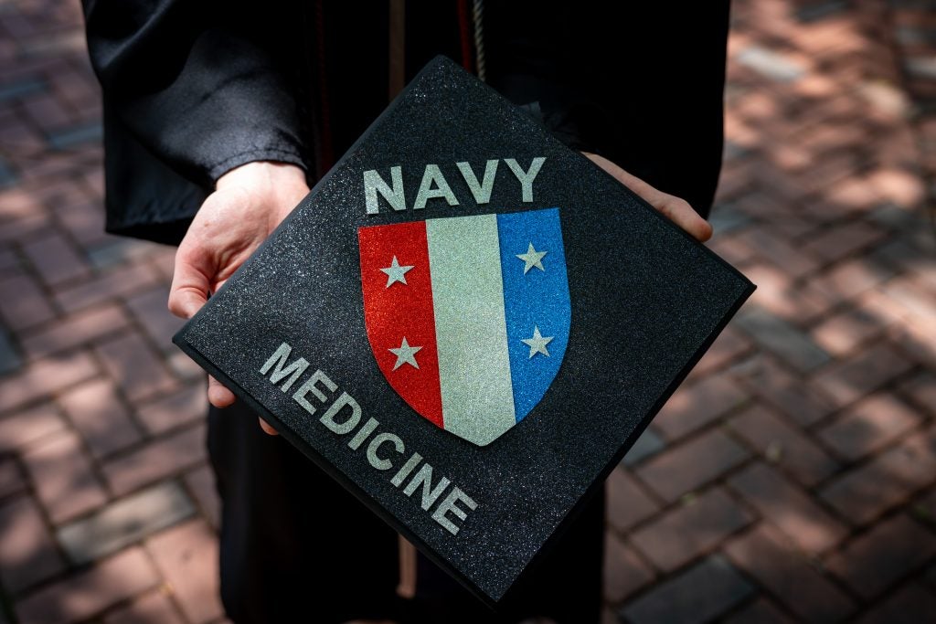 A decorated grad cap with a seal and Navy Medicine embossed