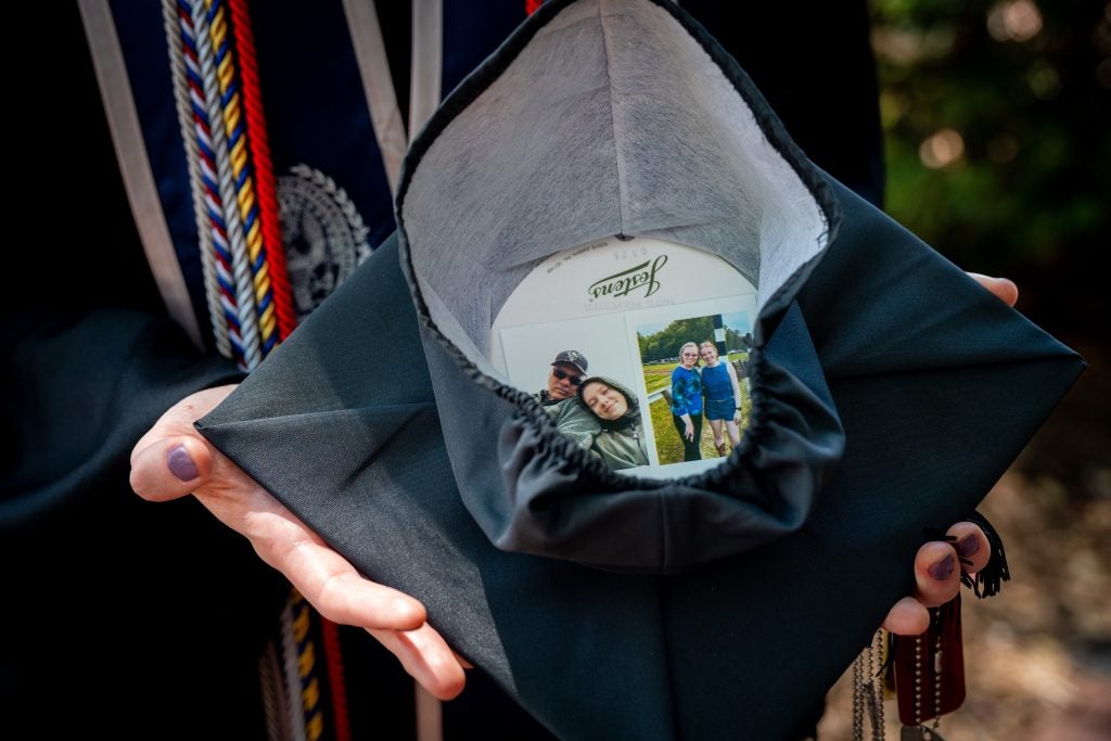 Inside of a graduation cap decorated with photos