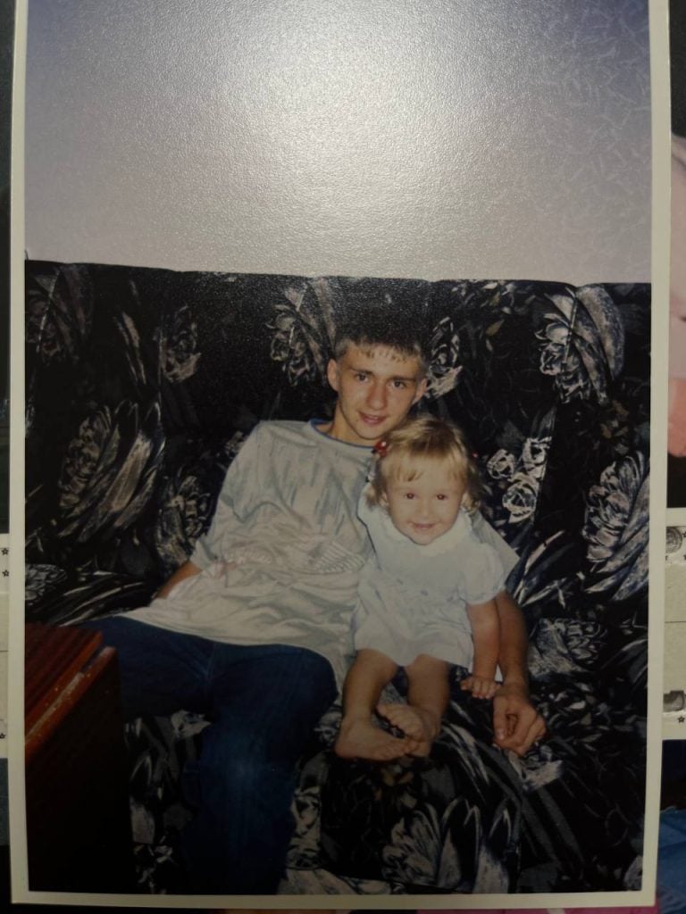 Old photo of a young boy with his younger sister