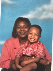 A childhood photo of a mom holding her son in a portrait session