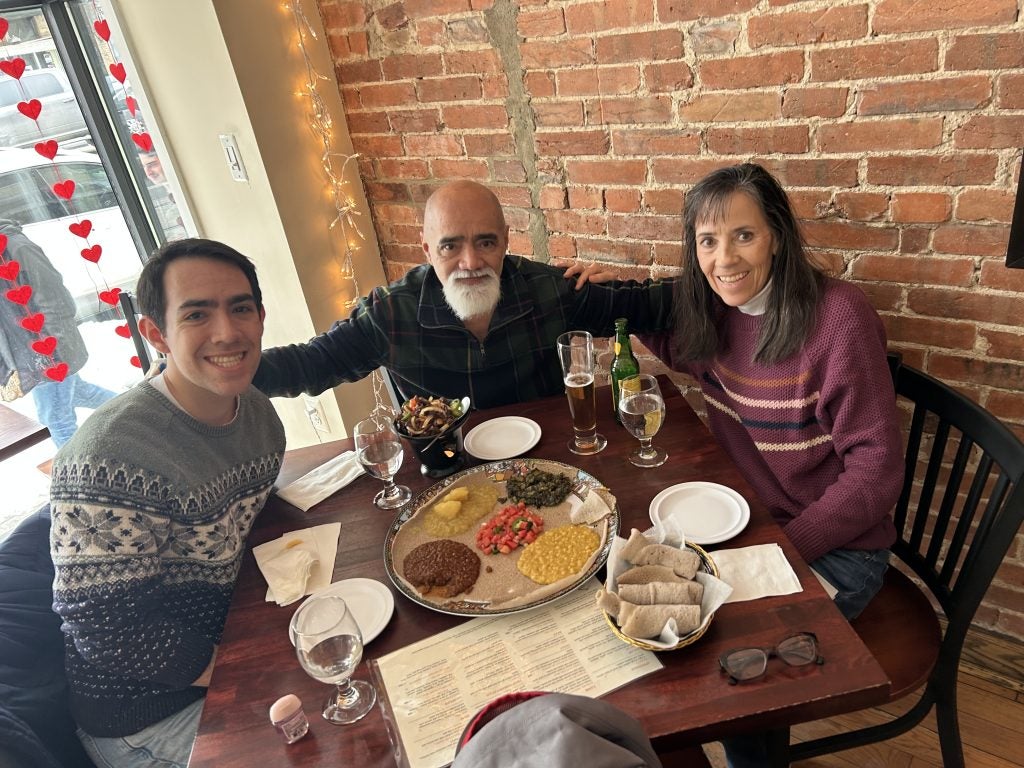 Young man with parents at a restaurant