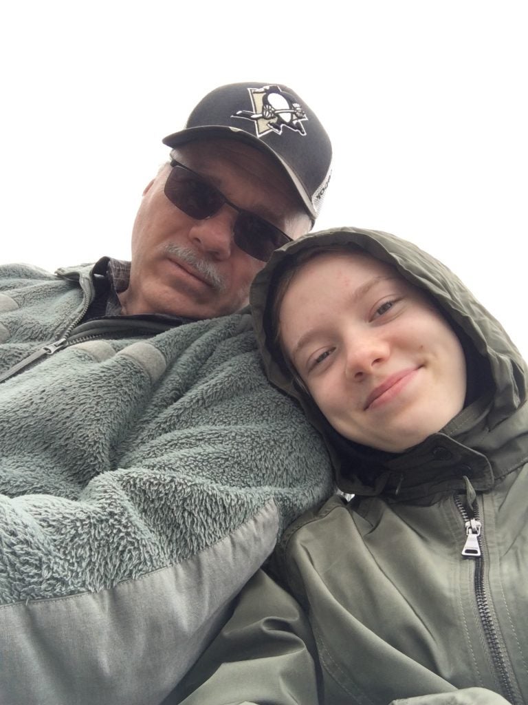 Young woman with her dad on a cloudy day