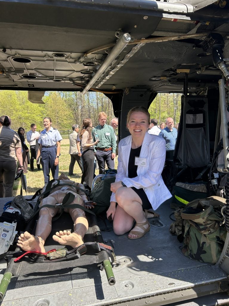 Young woman in a helicopter with a medical mannequin