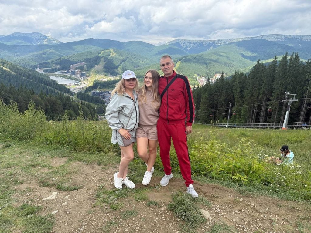 Young woman with her parents in the mountains