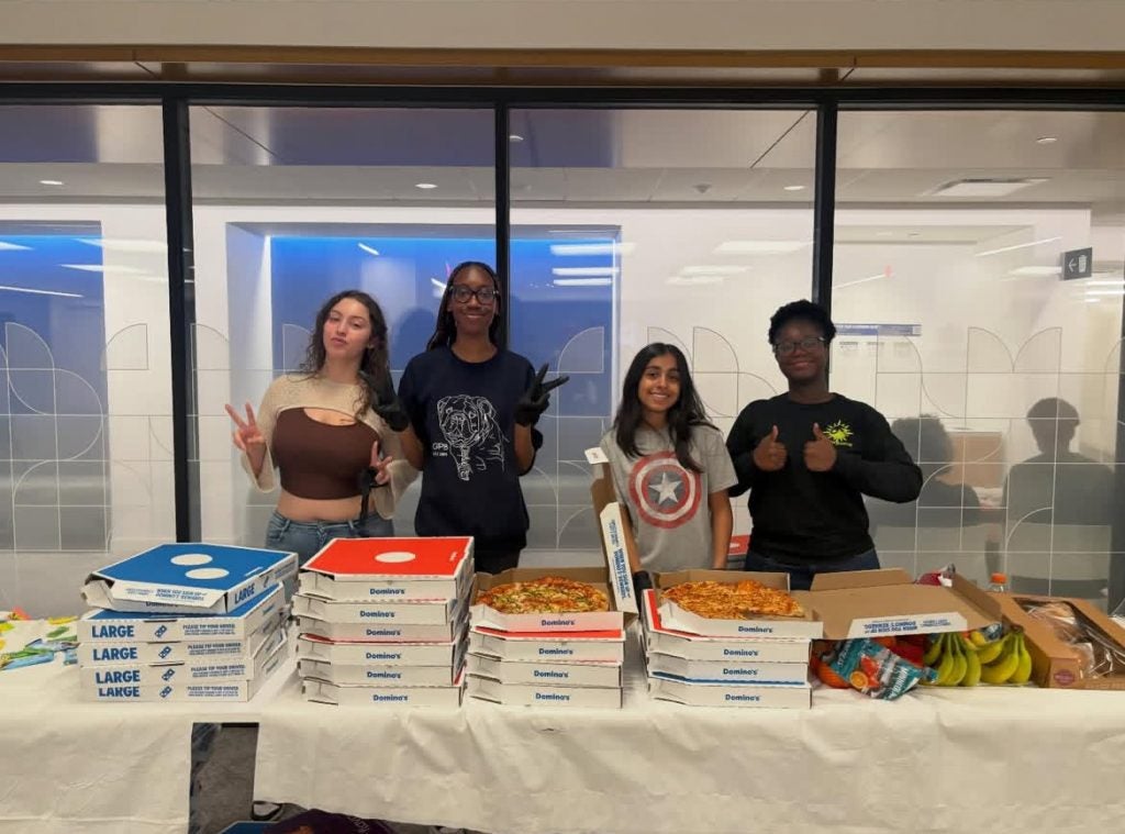 Young students serving pizza
