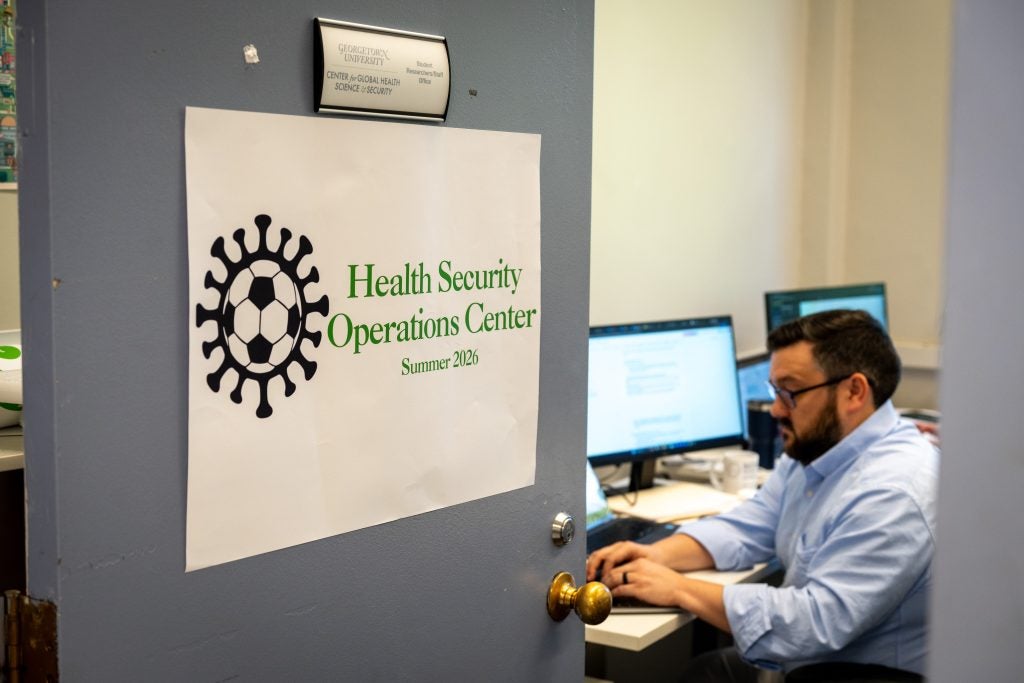A paper sign for the Health Security Operations Center taped to a door