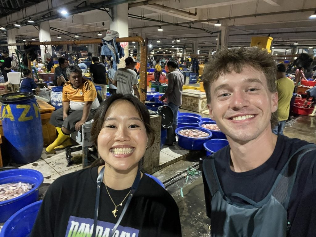 Young man with Asian woman smiling in selfie