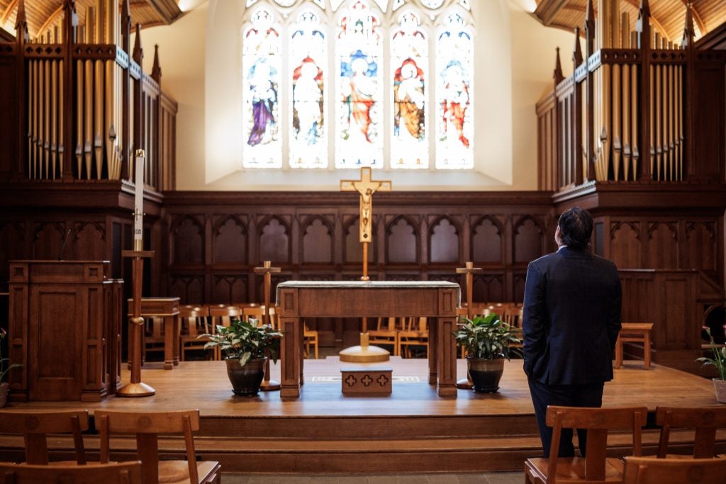 Georgetown President Eduardo Peñalver stands in front of the altar in a chapel