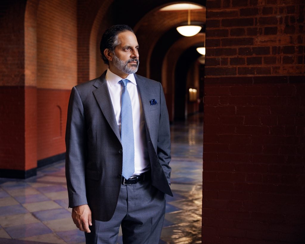 Georgetown President Eduardo Peñalver stares out a window on campus