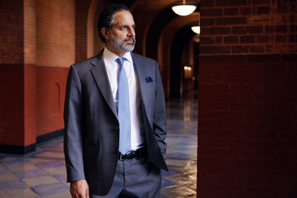 Georgetown President Eduardo Peñalver stares out a window on campus