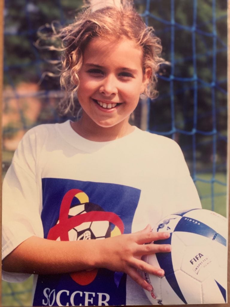 Young girl holding a soccer ball