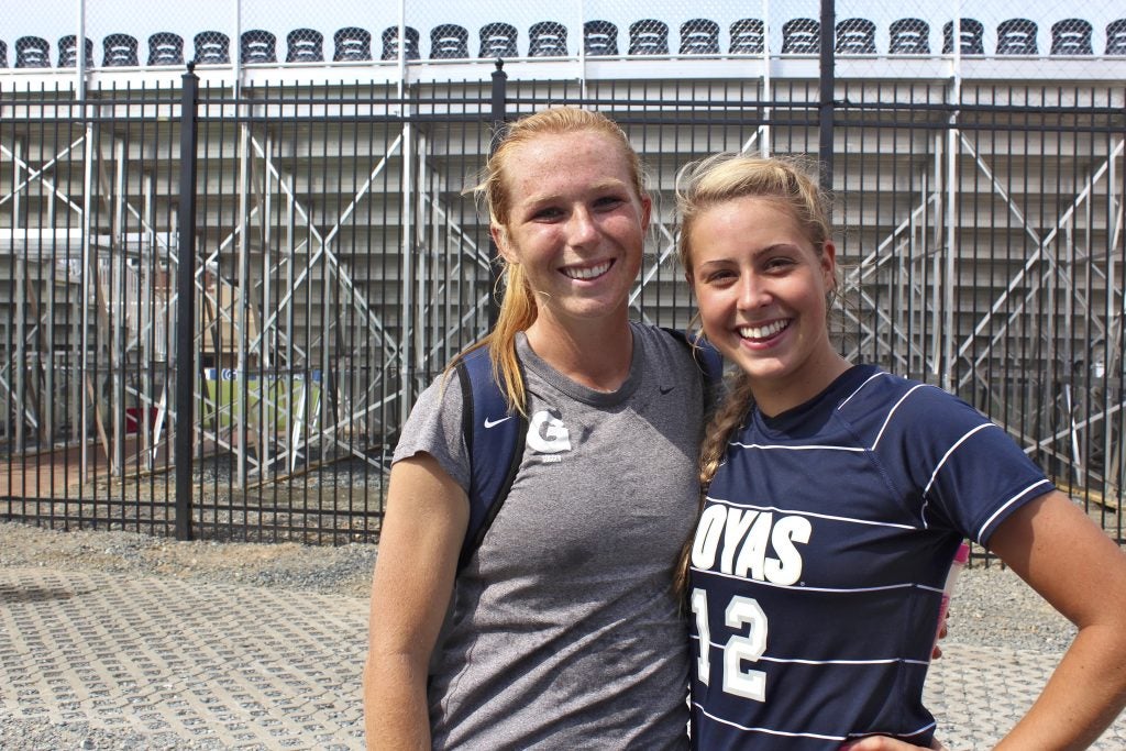 Two young women smiling in soccer attire