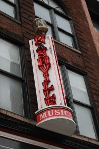 A close-up of a sign that says "Nashville Music" in red letters