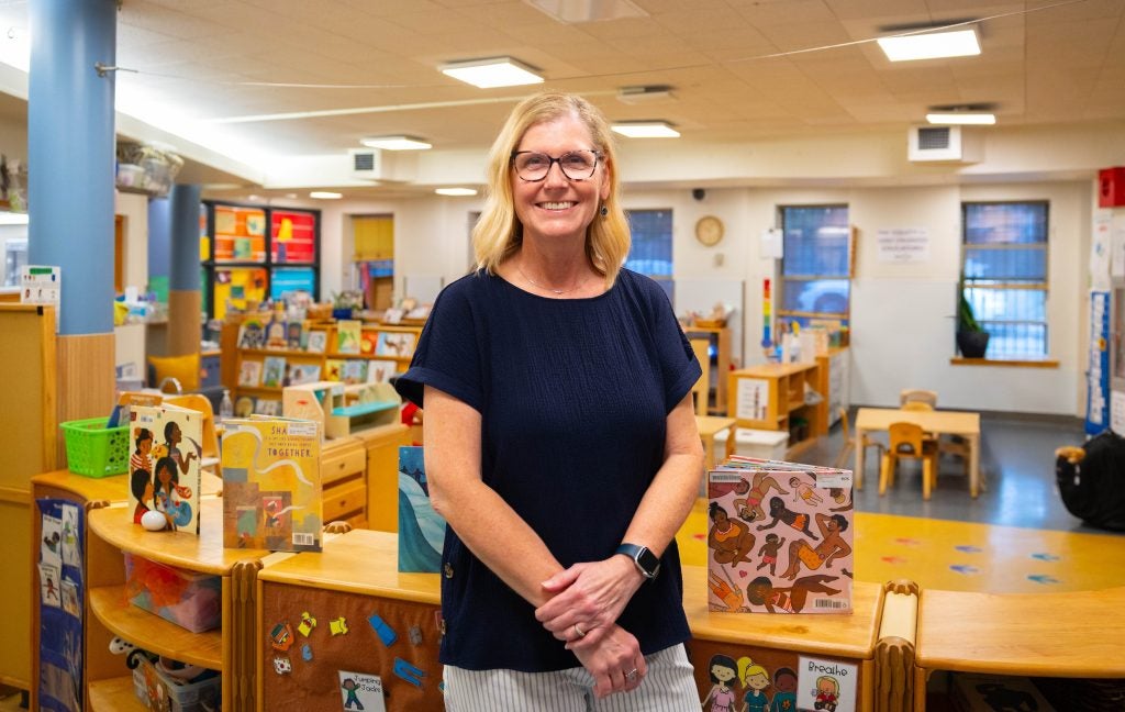 A woman stands in front of a children's play area