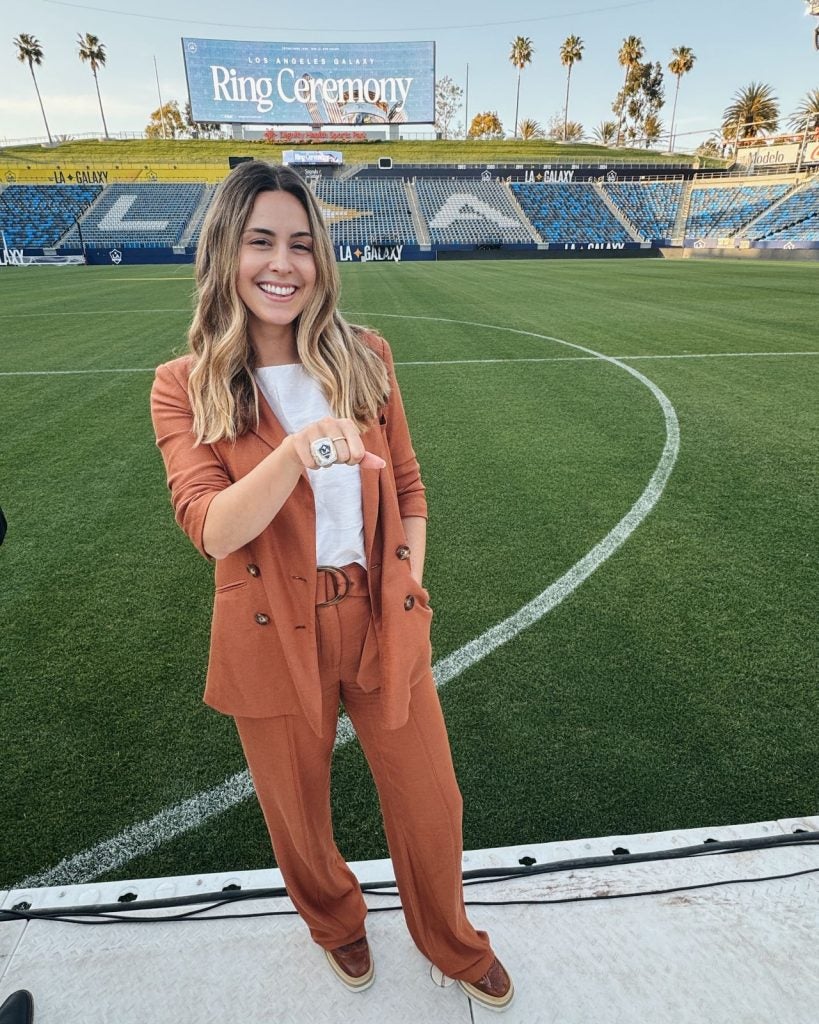 Young woman with a championship ring on a soccer field