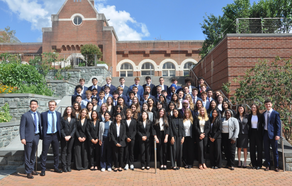 Students in business attire standing on steps