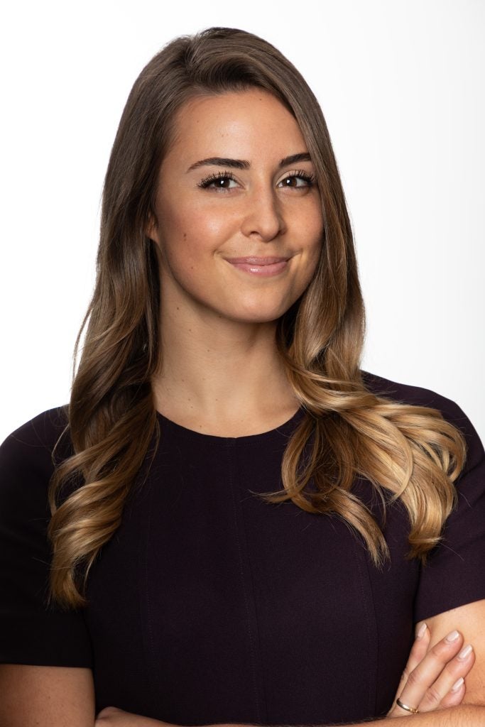 Woman in a black blouse smiling for portrait
