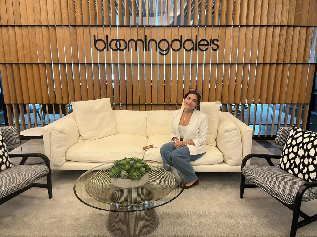 Young women on a couch under a bloomingdale's sign
