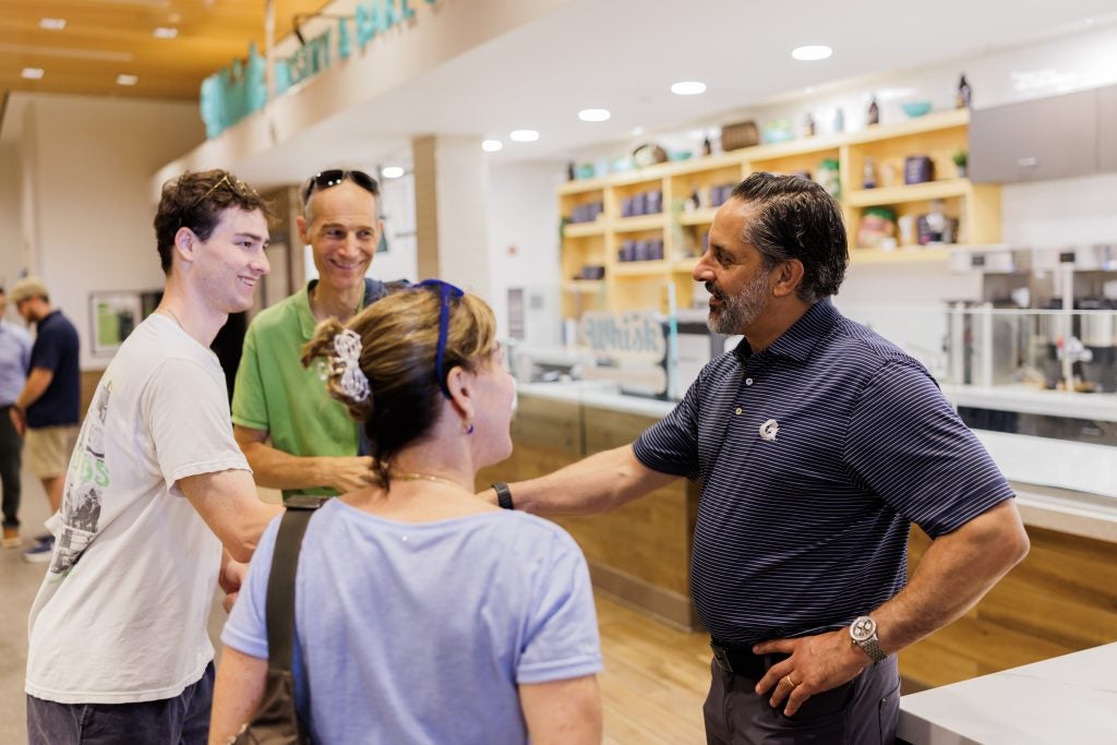 Eduardo Peñalver greets a family at the dining hall