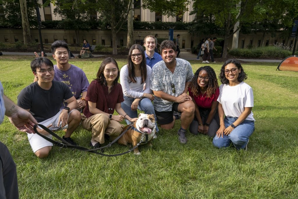 Students with Jack the Bulldog on a lawn