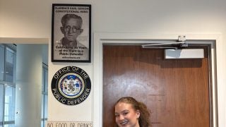A student poses outside the Maryland Public Defender's Office